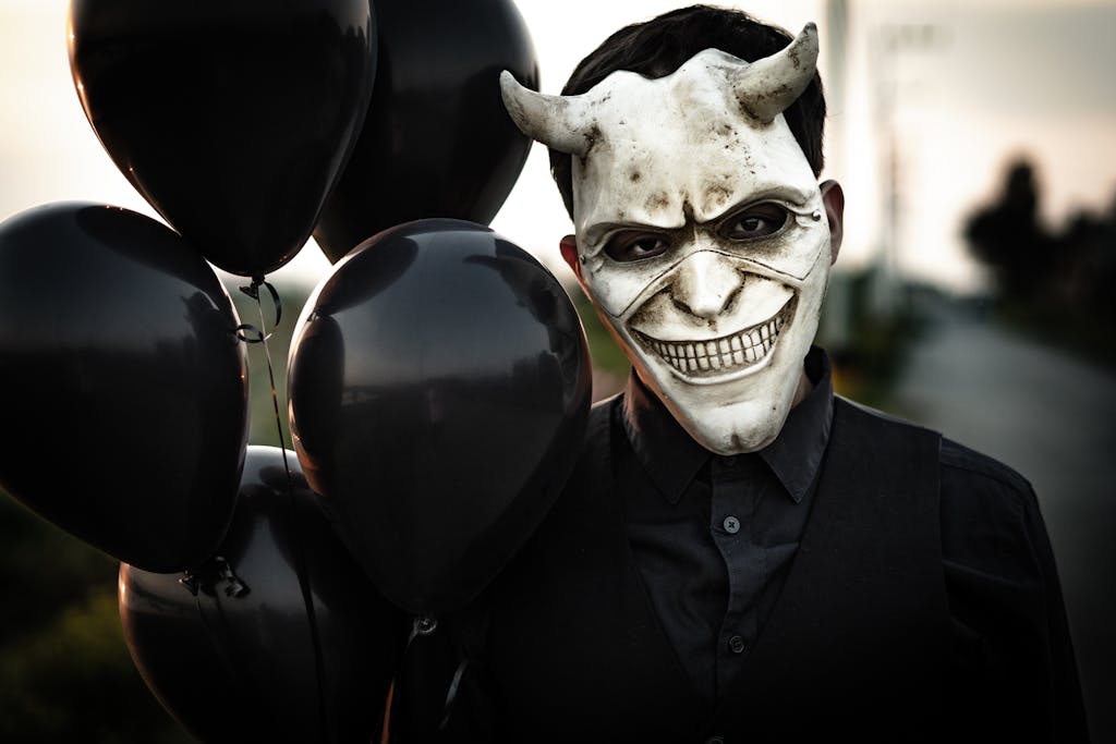 Man in Black Suit With White Mask